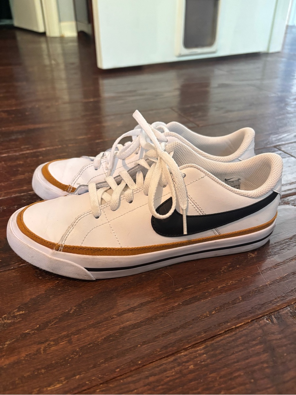 Nike White Low-Top Sneakers with Black Swoosh and Gold Accent Womens/mens